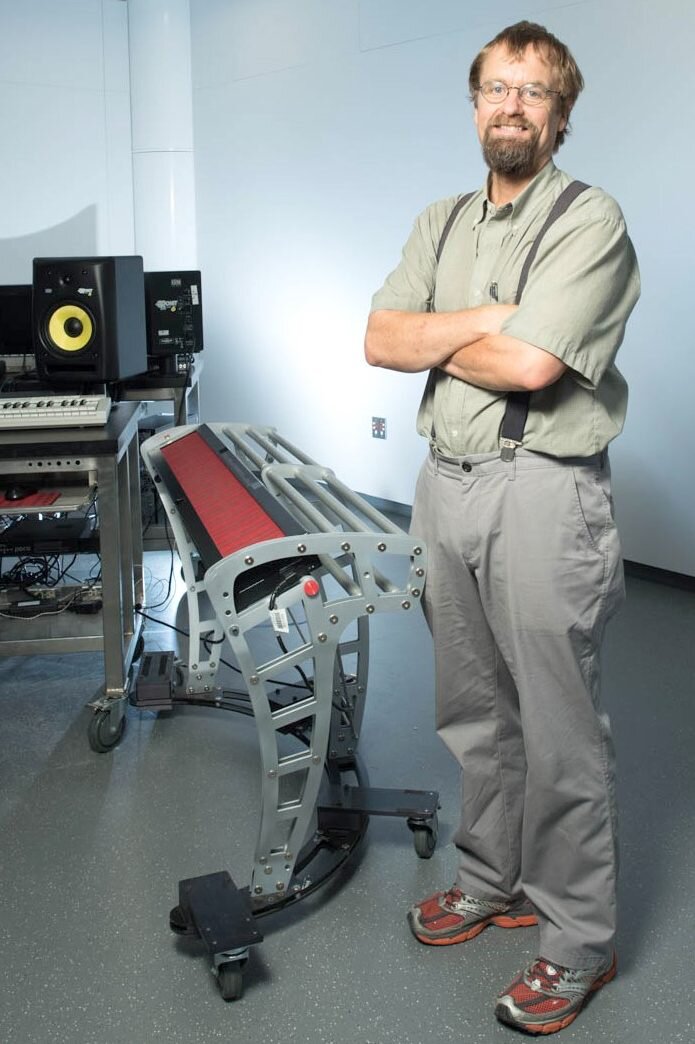 Lippold Haken standing beside a Continuum Fingerboard